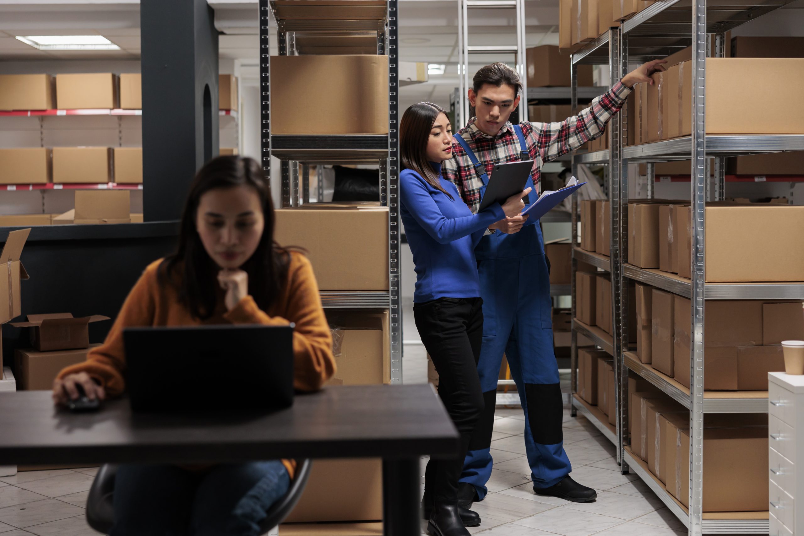 Warehouse worker and logistics manager doing products audit Warehouse worker and logistics manager doing products audit